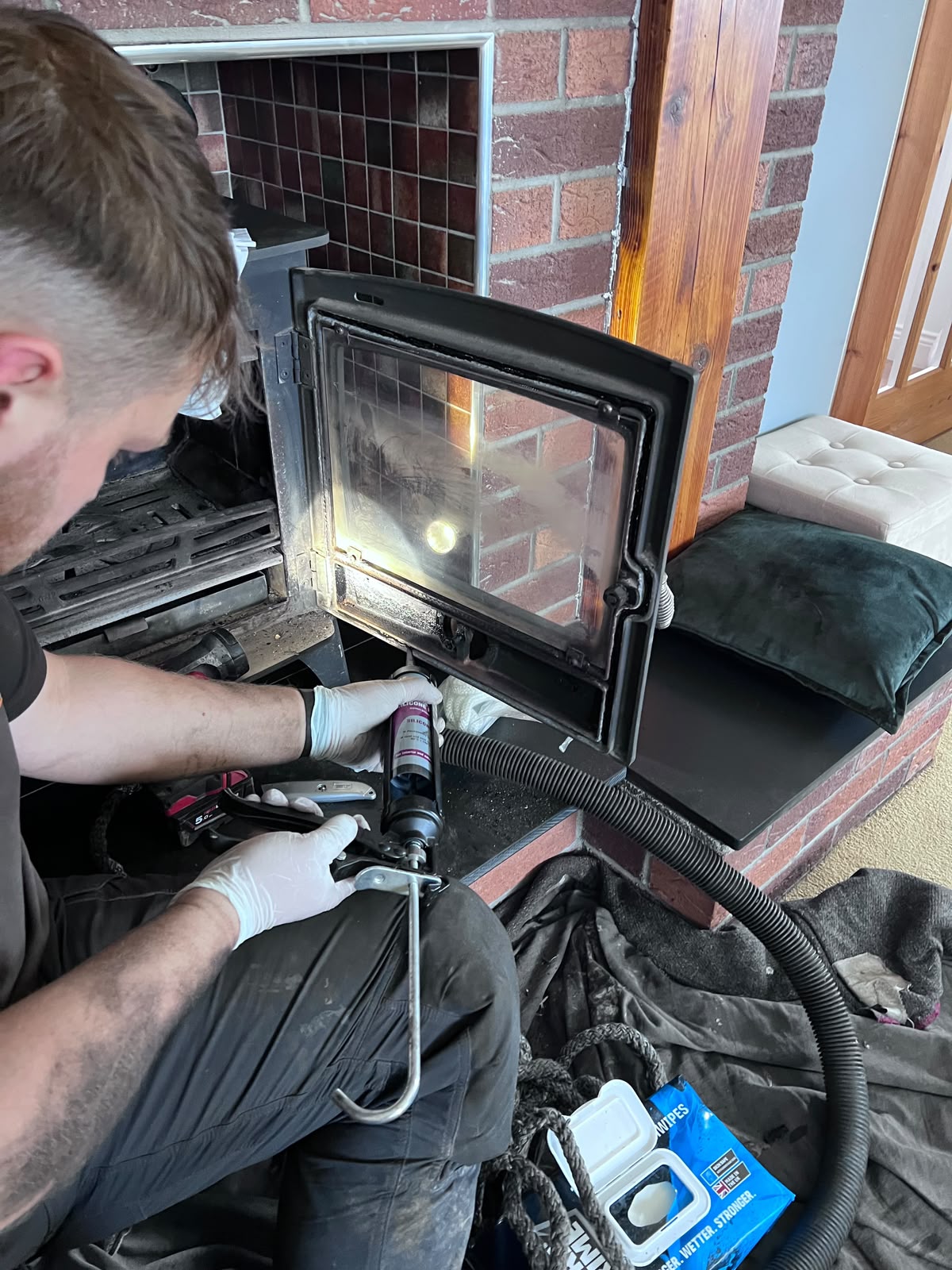 New rope seal being fitted to a stove door